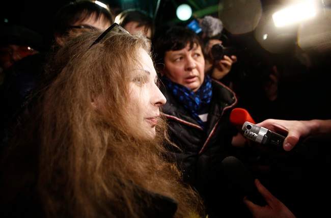 Members of Russian punk band Pussy Riot, Maria Alekhina, speaks to the media while leaving a train upon her arrival in Moscow, Russia, late Monday, Dec. 23, 2013. 