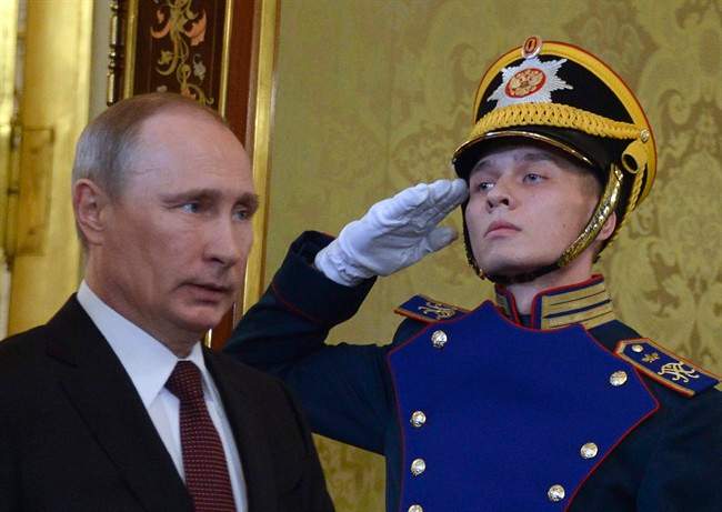 Russian President Vladimir Putin, left, walks to meet his Ukrainian counterpart Viktor Yanukovych during their meeting in Moscow on Tuesday, Dec. 17, 2013. 