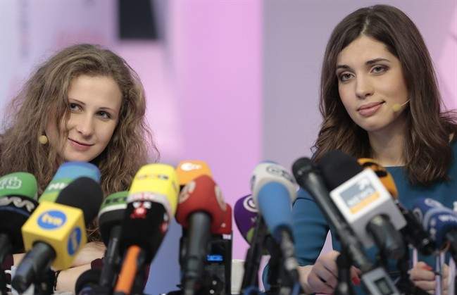 Russian punk band Pussy Riot members Nadezhda Tolokonnikova, right, and Maria Alekhina smile during their news conference in Moscow, Russia, on Friday, Dec. 27, 2013. 