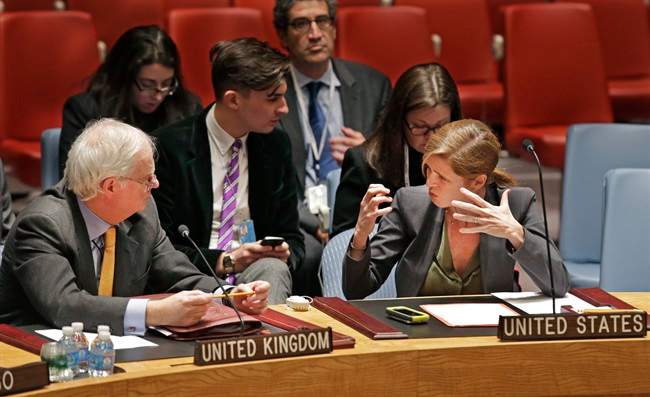 Great Britain's U.N. Ambassador Mark Lyall Grant, left, listens to Samantha Power, the United States U.N. Ambassador, before a United Nations Security Council meeting at U.N. headquarters Tuesday, Dec. 24, 2013 in New York.