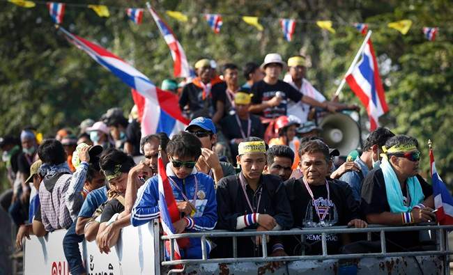 Anti-government protesters leave Democracy Monument to join other protesters in different locations in Bangkok, Thailand, Sunday, Dec. 8, 2013. 
