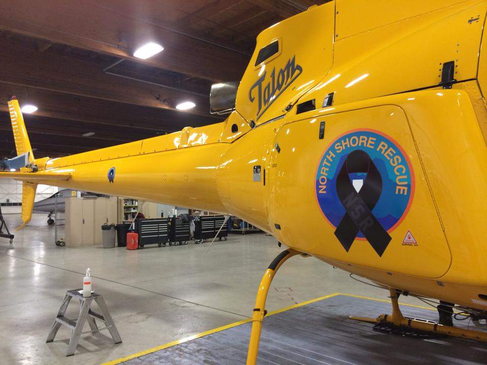 A Talon A-Star helicopter is adorned with a black ribbon to honour Tim Jones at his memorial service.