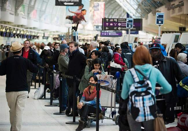 Frustrated passengers line-up during flight delays and cancellations due to extreme cold weather and wind chill at Pearson International Airport in Toronto on Tuesday January 7, 2014.