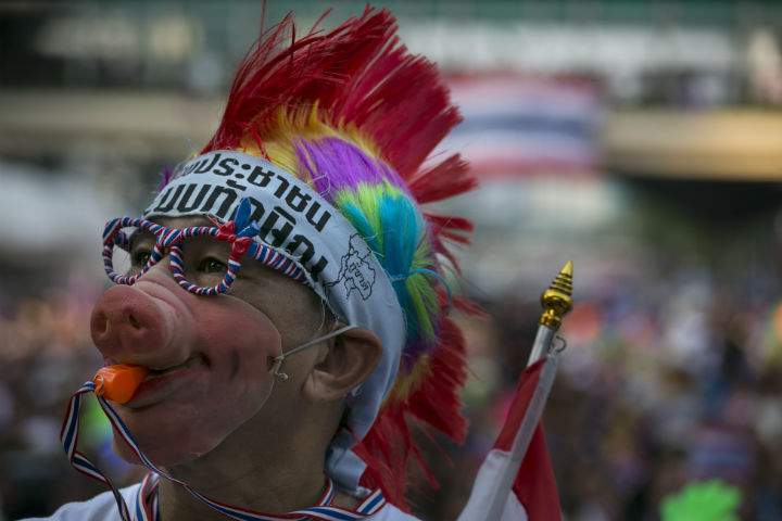 Anti-government protesters listen to political speeches as they occupy the victory monument in central Bangkok
