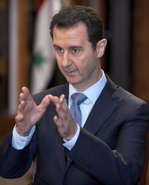 were tortured and slain by Assad's regime. In this photo released by the Syrian official news agency SANA, Syrian President Bashar Assad speaks during an interview in Damascus, Syria, Sunday, Jan. 19, 2014. France, which is hosting the closed-door meeting, says the photos to be displayed are part of a collection of 55,000 digital images of Syrians who were tortured and slain by Assad's regime.