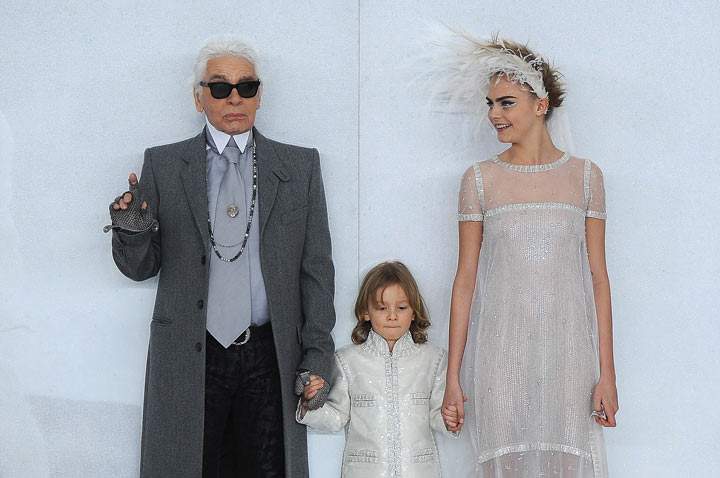 (L-R) Fashion designer Karl Lagerfeld, his godson Hudson Kroenig and model Cara Delevingne walk the runway during the Chanel show as part of Paris Fashion Week Haute-Couture Spring/Summer 2014 on January 21, 2014 in Paris, France. (Photo by Pascal Le Segretain/Getty Images)
