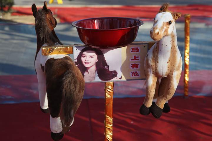 The horse toys are seen at a game area of the Spring Festival Temple Fair for celebrating Chinese Lunar New Year of Horse at the Temple of Earth park on Jan. 30, 2014 in Beijing, China. (Photo credit: Feng Li/Getty Images)