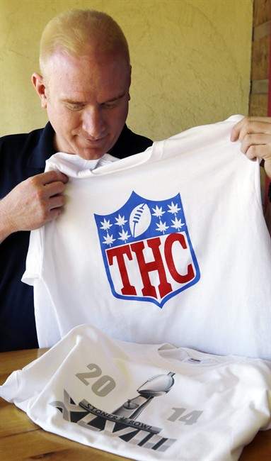 In this Friday, Jan. 24, 2014 photo, Bryan Weinman shows two of his "Stoner Bowl" T-shirts in southeast Denver. 