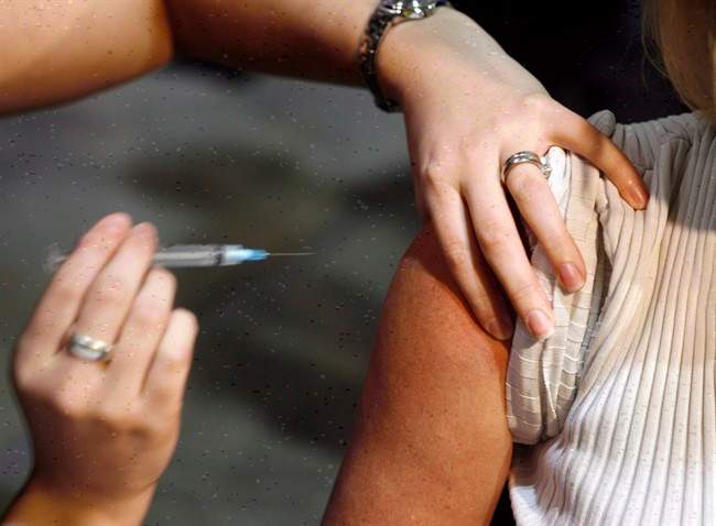 A patient gets a shot during a flu vaccine.