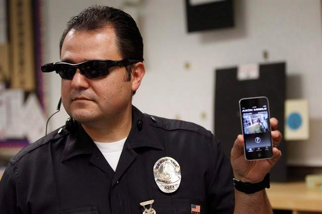 Los Angeles Police Sgt. Daniel Gomez demonstrates a video feed from his camera into his cellphone as on-body cameras are demonstrated for the media.