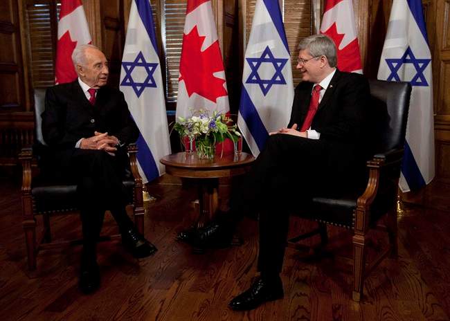 Israel President Shimon Peres talks with Canadian Canadian Prime Minister Stephen Harper before a meeting on Parliament Hill in Ottawa, Monday May 7, 2012. Harper will make history in Israel next week when he becomes the first Canadian leader to address the Israeli legislature. THE CANADIAN PRESS/Adrian Wyld.