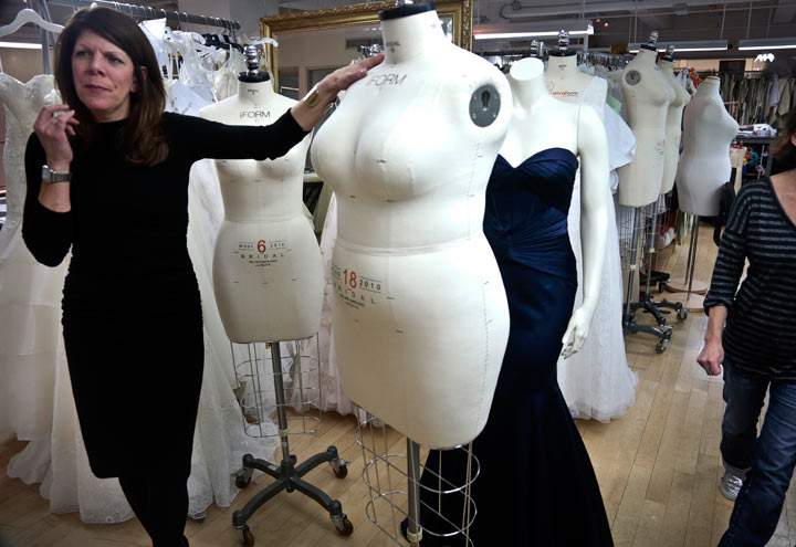 In this Dec. 17, 2013 photo, David's Bridal senior vice president Michele von Plato shows a plus-size mannequin during an interview in New York. David’s Bridal, the nation’s largest bridal chain, started changing its fit mannequins used to create gowns to reflect the average body. 