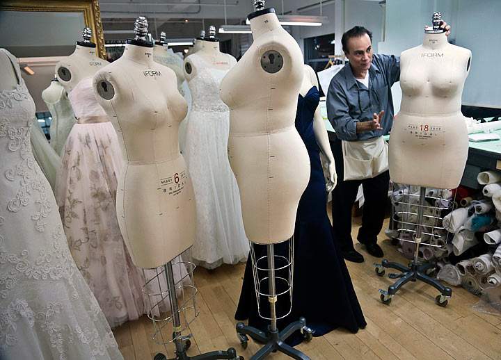 In this Dec. 17, 2013 photo, David’s Bridal dressmaker Noel Belancourt, wheels a plus-size mannequin to his workstation in New York. David’s Bridal, the nation’s largest bridal chain, started changing its fit mannequins used to create gowns to reflect the average body.
