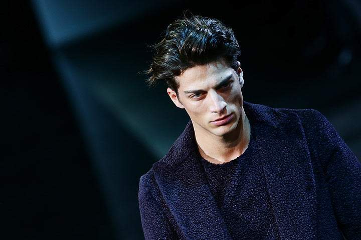 A model walks the runway during the Emporio Armani show as a part of Milan Fashion Week Menswear Autumn/Winter 2014 on January 13, 2014 in Milan, Italy. (Photo by Vittorio Zunino Celotto/Getty Images)