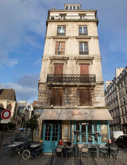 In this Wednesday, Jan. 8, 2014 photo, an elderly couple sits outside the Chez Julien restaurant at the the Marais District in Paris. You can start your walk on the Rue Saint-Jacques, which begins across the street from the restaurant Les Papilles and will take you all the way to the Seine, over a bridge to Ile de la Cite and to the plaza in front of Notre Dame cathedral. The facade has been cleaned recently for the church’s 850th anniversary, and it is particularly stunning at night.