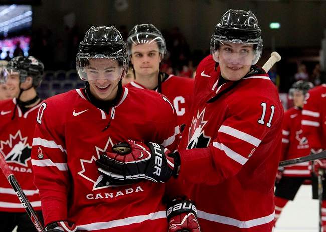 Canada's Charles Hudon (10) and Bo Horvat (11) celebrate as they skate off the ice after defeating the USA 3-2 at the IIHF World Junior Hockey Championships in Malmo, Sweden on Tuesday December 31, 2013. THE CANADIAN PRESS/ Frank Gunn.