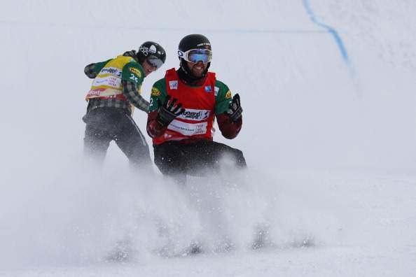 Canada's Kevin Hill reacts at the end of the second semi final in front of Finland's Amnton Lindfors at the men's snowboard cross event as part of the FIS Snowboard world cup season opening, in Schruns Montafon on December 7, 2013.