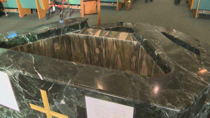 The holy water font at St. Thomas More Catholic Church in Edmonton has been emptied.