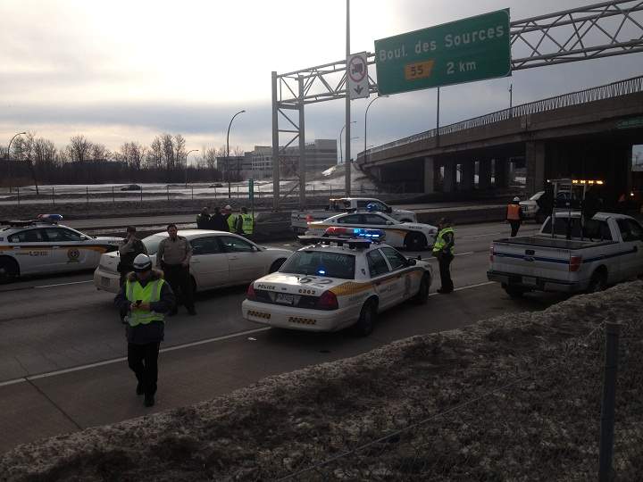 Investigators working to determine the cause of the falling debris along the Trans-Canada Highway in Montreal on January 13, 2014.