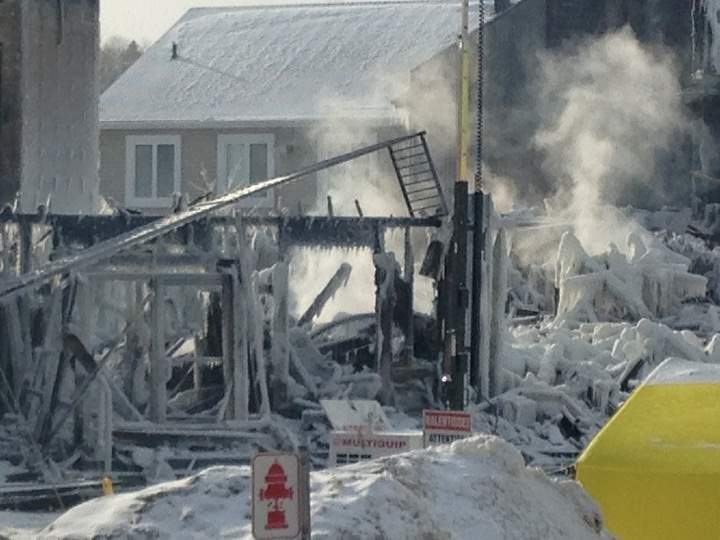A glimpse of the still-smoking ruins of the seniors' home in L'Isle Verte, Que. on Friday, January 24, 2014.