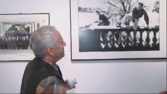 Jean-Marc Carisse at his gallery cafe in Ottawa, looking at one of his famous photographs.
