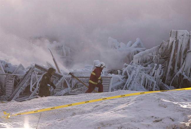 Firefighters work at the scene of a fatal fire at a seniors residence in L'Isle-Verte, Que., Thursday, January 23, 2014.
