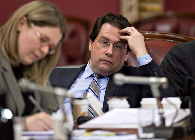 Quebec Minister Bernard Drainville listens to a participant during a legislature committee studying the proposed Charter of Values on secularism, Tuesday, January 14, 2014 in Quebec City.