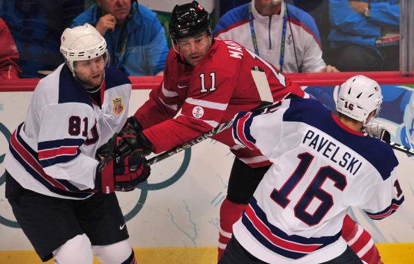 USA forwards Phil Kessel (L) and Joe Pavelski fight for the puck with Canada's forward Patrick Marleau during the Men's preliminary Ice Hockey match Canada against USA at the XXI Winter Olympic games in Vancouver's Canada Hockey Place on February 21, 2010.