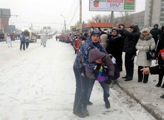In this photo provided by Pavel Lebedev, security personnel detain Lebedev, a gay protester, during the Olympic torch relay in the city of Voronezh, 534 km (334 miles) south of Moscow, Saturday, Jan. 18, 2014. 