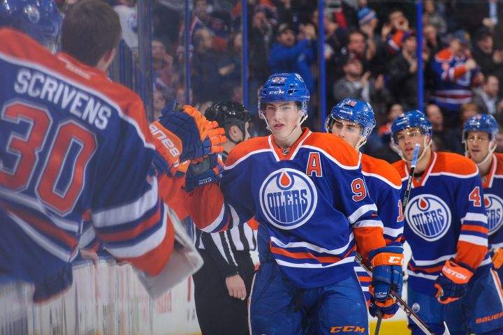 Ryan Nugent-Hopkins #93 of the Edmonton Oilers celebrates with the bench after scoring his team's third goal against the Phoenix Coyotes during an NHL game at Rexall Place on January 24, 2014 in Edmonton.