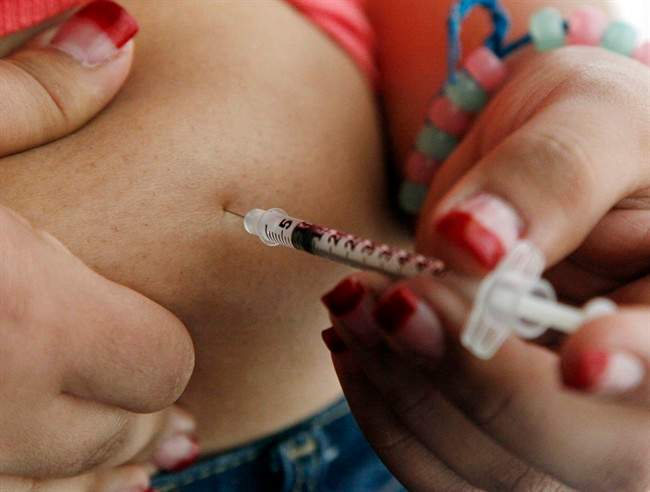 FILE - In this Sunday, April 29, 2012 file photo, a 19-year old diagnosed with diabetes gives herself an injection of insulin at her home in the Los Angeles suburb of Commerce, Calif.