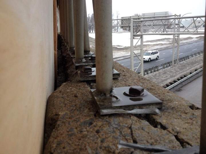A gap can be seen between the concrete overpass and a wooden plank installed by Transports Quebec on the Henri-Bourassa overpass in Montreal on January 14, 2014.