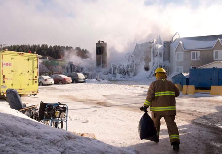 A fire destroyed the residence and police said three people were confirmed dead and 30 are missing. (Photo credit: The Canadian Press)