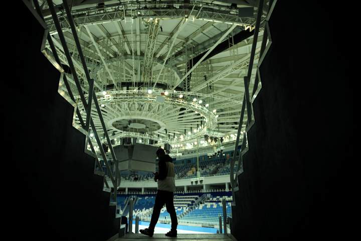 A picture taken on September 25, 2013, shows a man walking inside the Bolshoi Ice Dome arena, an ice hockey venue, in the Olympic Park in the Russian Black Sea resort of Sochi. Sochi will host the 2014 Winter Olympics that start on February 7, 2014 . (Photo credit: Getty Images)