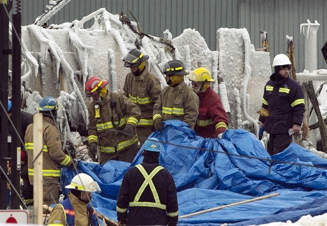 Emergency workers continue the search for victims Saturday, January 25, 2014 in L'Isle-Verte, Que. at the scene of a fatal fire at a seniors residence. 