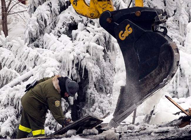 Firefighters work at the scene of a fatal fire at a seniors residence in L'Isle-Verte, Que., Thursday, January 23, 2014.