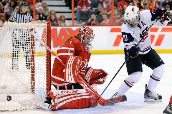 Meghan Duggan #10 of Team USA deflects the puck wide on Shannon Szabados #1 of Team Canada during the IIHF Womens World Championship Gold Medal Game at Scotiabank Place on April 9, 2013 in Ottawa.