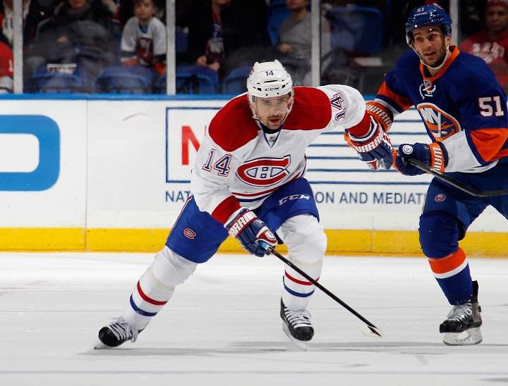 Tomas Plekanec skates against the New York Islanders at the Nassau Veterans Memorial Coliseum on December 14, 2013 in Uniondale, New York.