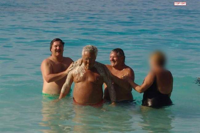 A photograph of a high-powered union boss having his back washed by a construction magnate while on vacation caused a stir at Quebec's corruption inquiry on Monday, Jan. 20, 2014. The 2005 photo entered into evidence shows businessman Tony Accurso scrubbing the back of Jean Lavallee, a former head of the construction wing of Quebec's biggest labour federation.