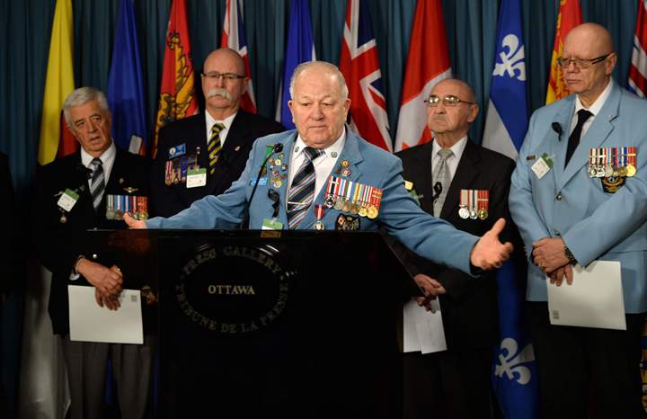 Veteran Ron Clarke joins fellow Veterans and PSAC members as they hold a news conference on Parliament Hill in Ottawa on Tuesday, January 28, 2014. 