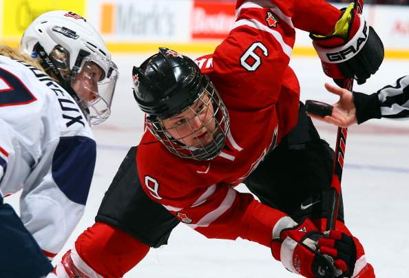  Jennifer Wakefield #9 of Team Canada takes a face-off against Team USA during a Sochi preparation game at the Air Canada Centre December 30, 2013 in Toronto.