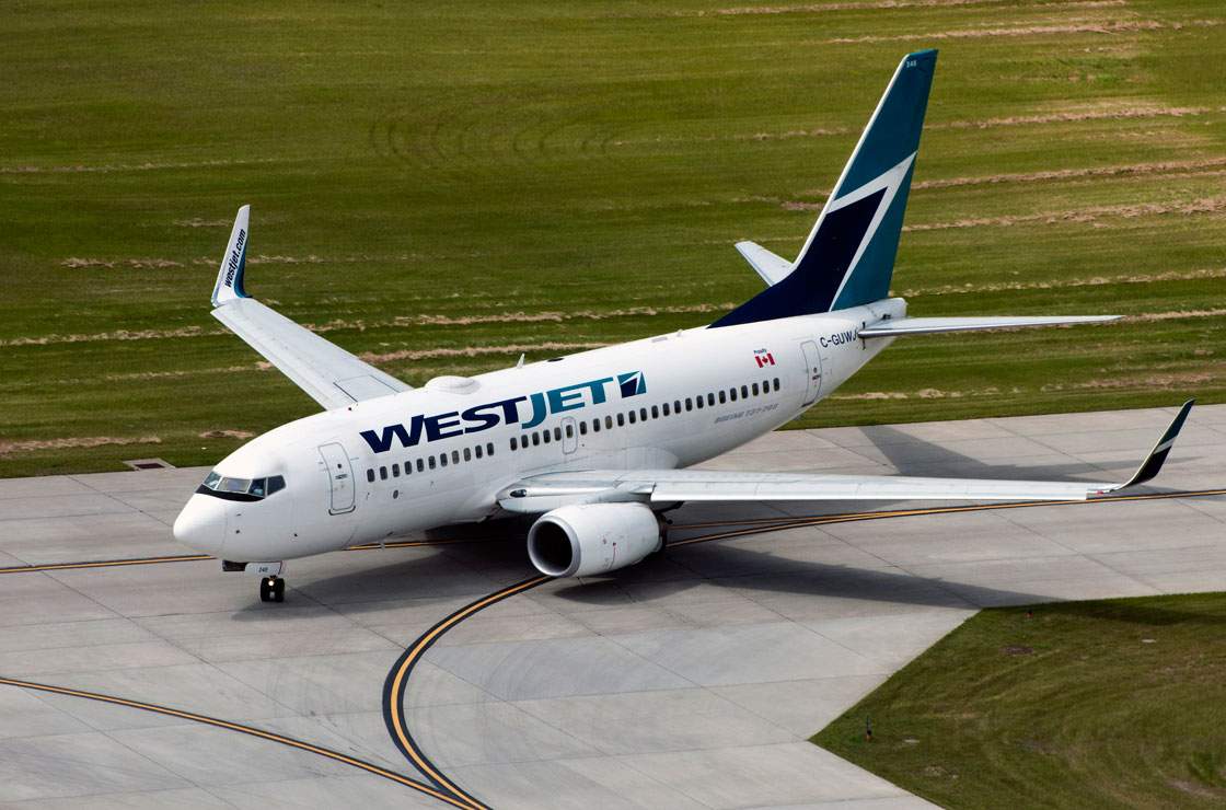 WestJet is resisting a move to adopt a new 'currency surcharge' being introduced by other operators.