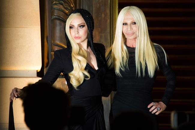 Lady Gaga, left, and fashion designer Donatella Versace arrive to the attend Atelier Versace Spring-Summer 2014 Haute Couture fashion collection, presented Sunday, Jan. 19, 2014 in Paris. (Photo by: AP Photo/Zacharie Scheurer)