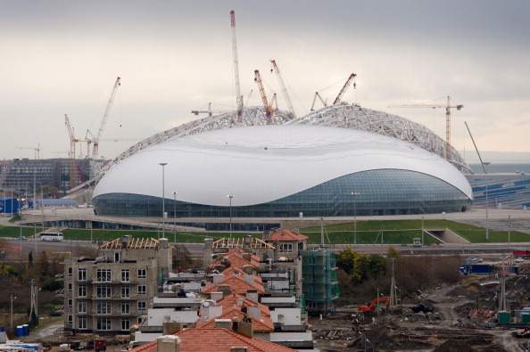 The Bolshoy Ice Dome is seen beyond the partially-completed buildings of the athletes village in the Sochi district of Adler, on February 18, 2013.