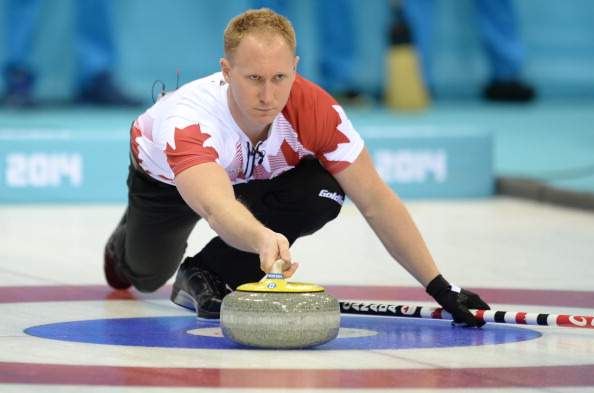 Canada’s Brad Jacobs releases a stone during the 2014 Sochi winter olympics men’s curling round robin session 1 match against Germany at the Ice Cube curling centre in Sochi on February 10, 2014.