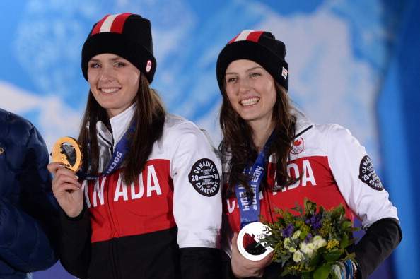 Canada's silver medallist Kelsey Serwa (R) and Canada's gold medallist Marielle Thompson pose during the Women's Freestyle Skiing Ski Cross Medal Ceremony at the Sochi medals plaza during the Sochi Winter Olympics on February 21, 2014. AFP PHOTO / ANDREJ ISAKOVIC (Photo credit should read ANDREJ ISAKOVIC/AFP/Getty Images)