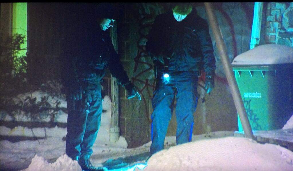 Police search the ground outside an apartment building on Tower Terrace.