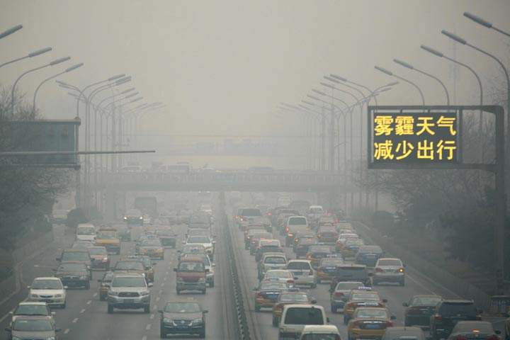 Vehicles clog a main highway during a sixth straight day of severe pollution in Beijing Tuesday, Feb. 25, 2014. (AP Photo/Ng Han Guan)