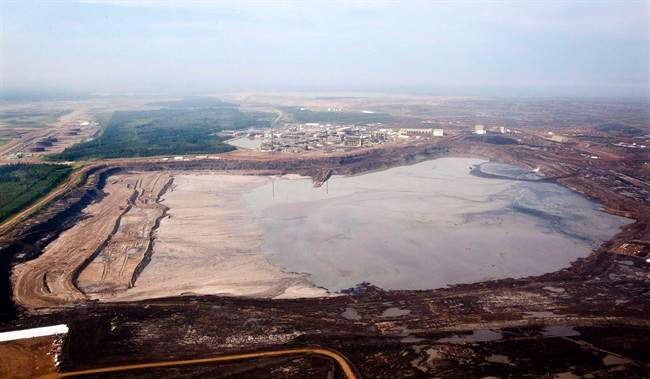 A tailings pond is picture at the Syncrude oilsands facility seen from a helicopter near Fort McMurray, Alta., July 10, 2012.