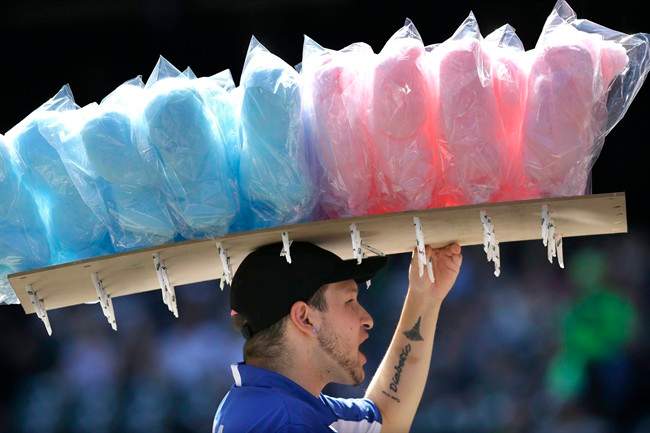 In this Sept. 8, 2013 file photo, a vendor sells cotton candy at Safeco field during a baseball game between the Tampa Bay Rays and the Seattle Mariners, in Seattle.